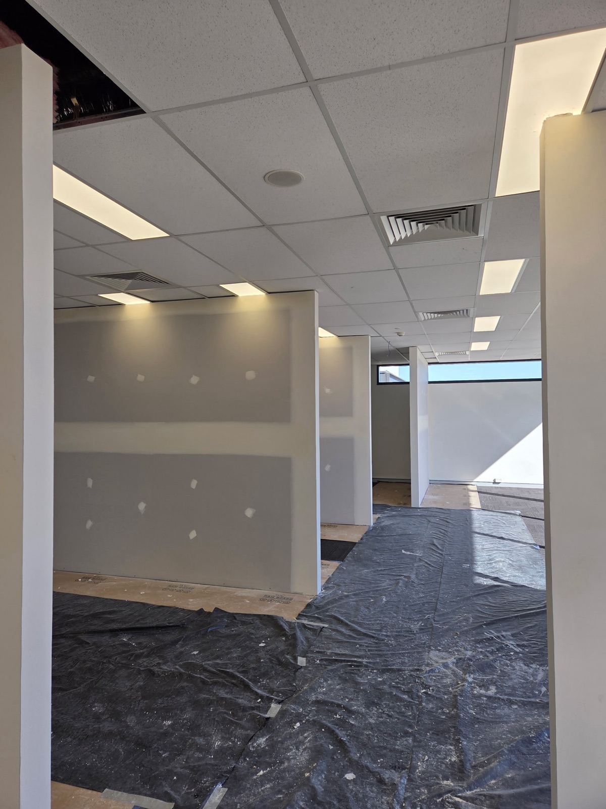 Newly framed plasterboard partition walls dividing a commercial fit-out, ready for finishing, Perth